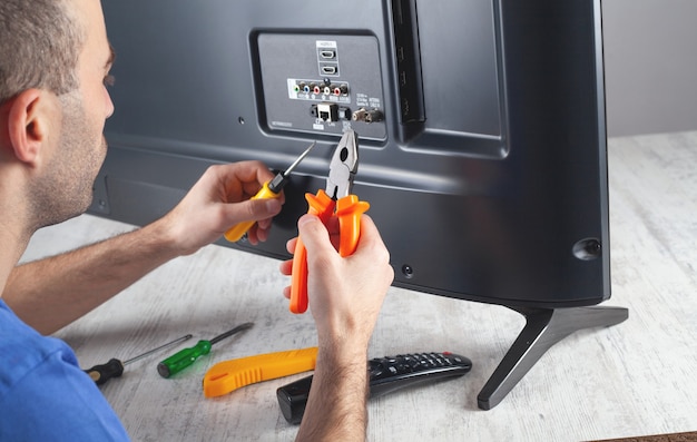 caucasian-engineer-repairing-tv-home_220873-4731 (1)